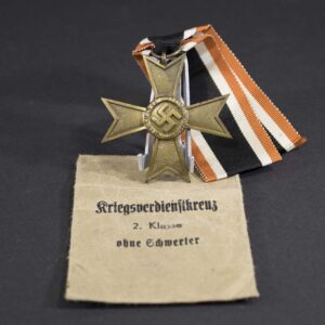 War Merit Cross with Swords displayed alongside original 'Lauer' marked award bag, complete WWII-era presentation set in very good condition.
