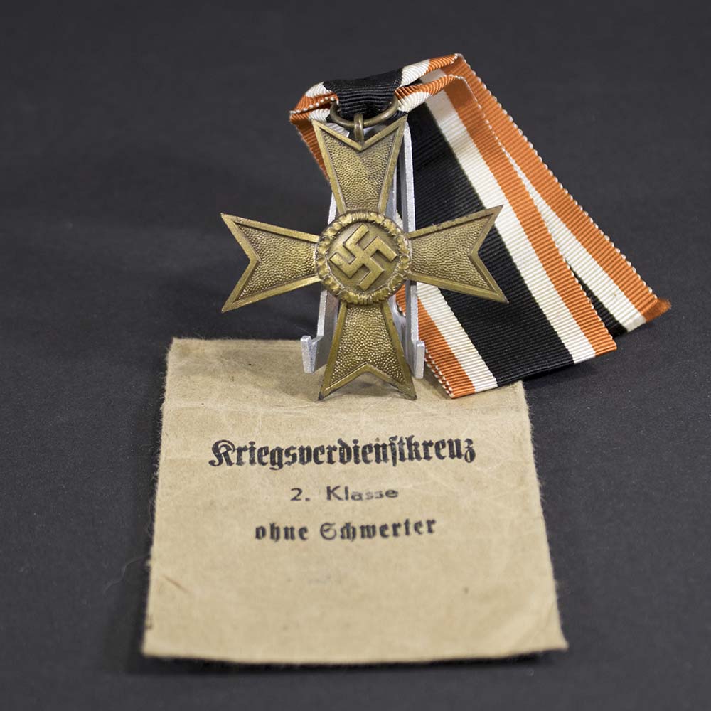 War Merit Cross with Swords displayed alongside original 'Lauer' marked award bag, complete WWII-era presentation set in very good condition.