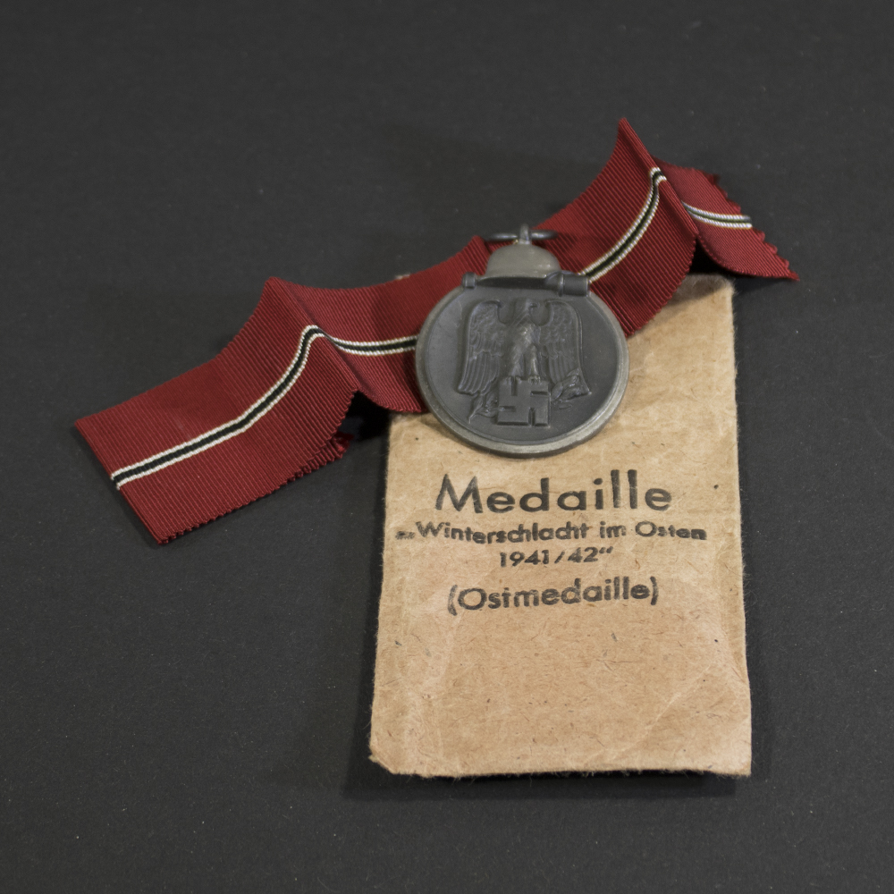 Full front view of the Eastern Front Medal (Ostmedaille) in very good condition, showing the eagle clutching a swastika above a crossed sword and branch.