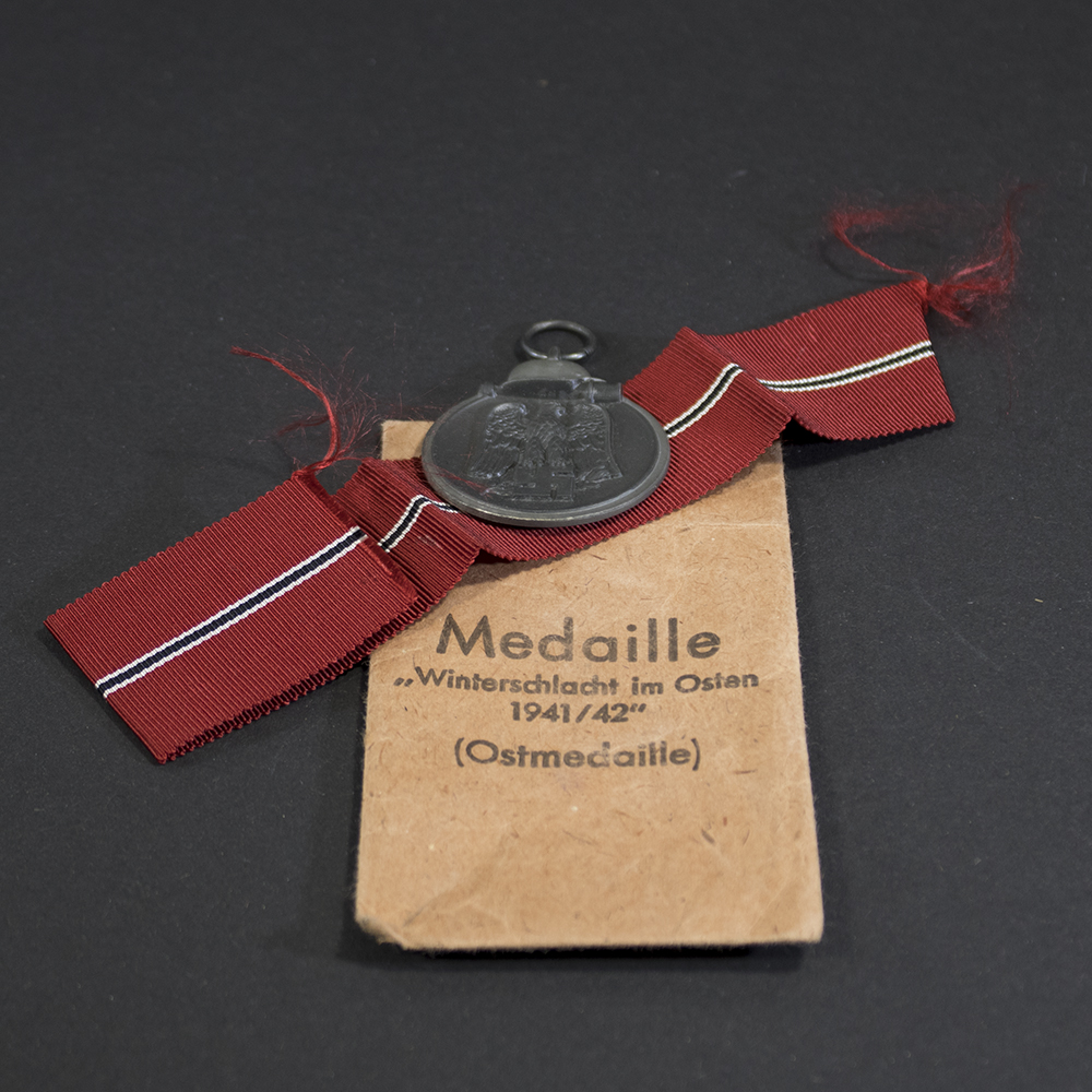 Full front view of the Eastern Front Medal (Ostmedaille) in very good condition, showing the eagle clutching a swastika above a crossed sword and branch.