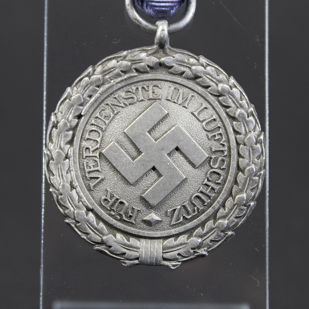 Detailed close-up of the front of the Luftschutz Air Defence Medal, highlighting the eagle motif and fine surface details.