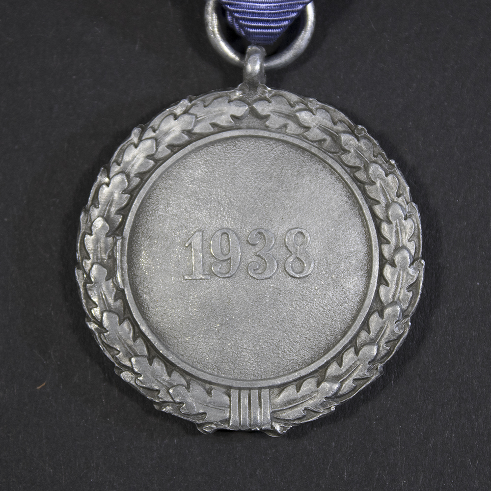Close-up of the reverse side of the medal, focusing on the suspension ring and ribbon attachment, showing no maker’s mark