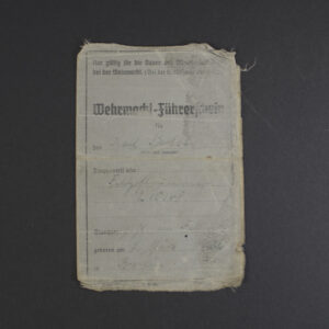Front view of an original WWII Wehrmacht Führerschein (German military driver’s license) in used condition, showing authentic cover details.