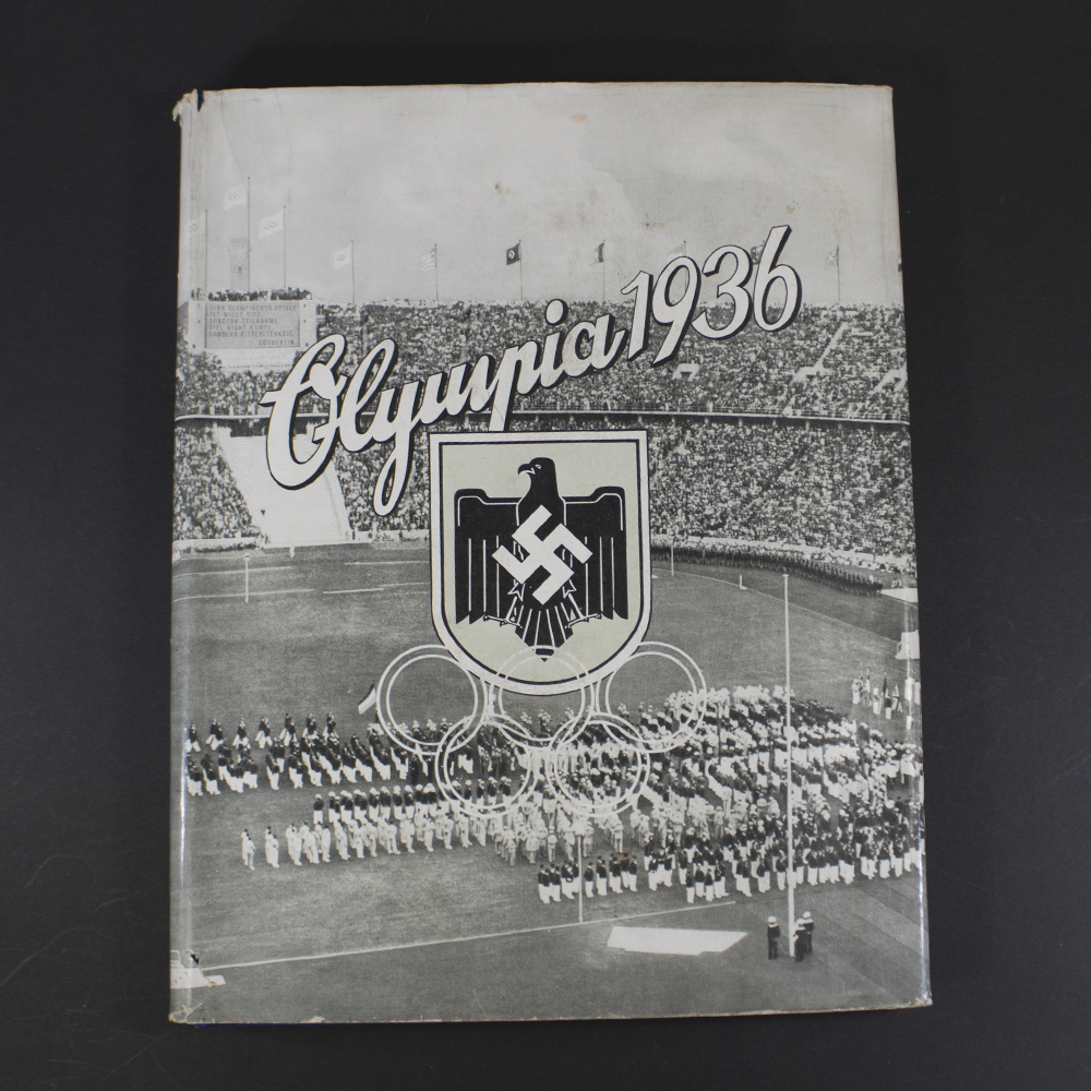 Front view of the cigarette album ‘Olympia 1936’ Summer Edition with dust cover, featuring Olympic rings and athlete illustration in vintage style