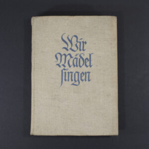 Front cover of the BDM songbook ‘Wir Mädel singen’ featuring the title in decorative Gothic script, an illustration of girls singing, and a simple border.