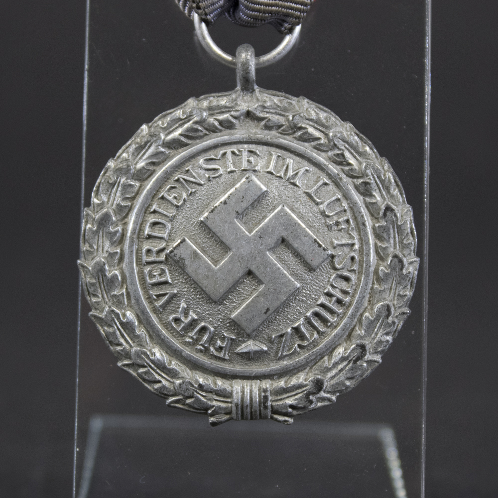 Detailed close-up of the Luftschutz medal’s front highlighting the swastika, and the inscription.