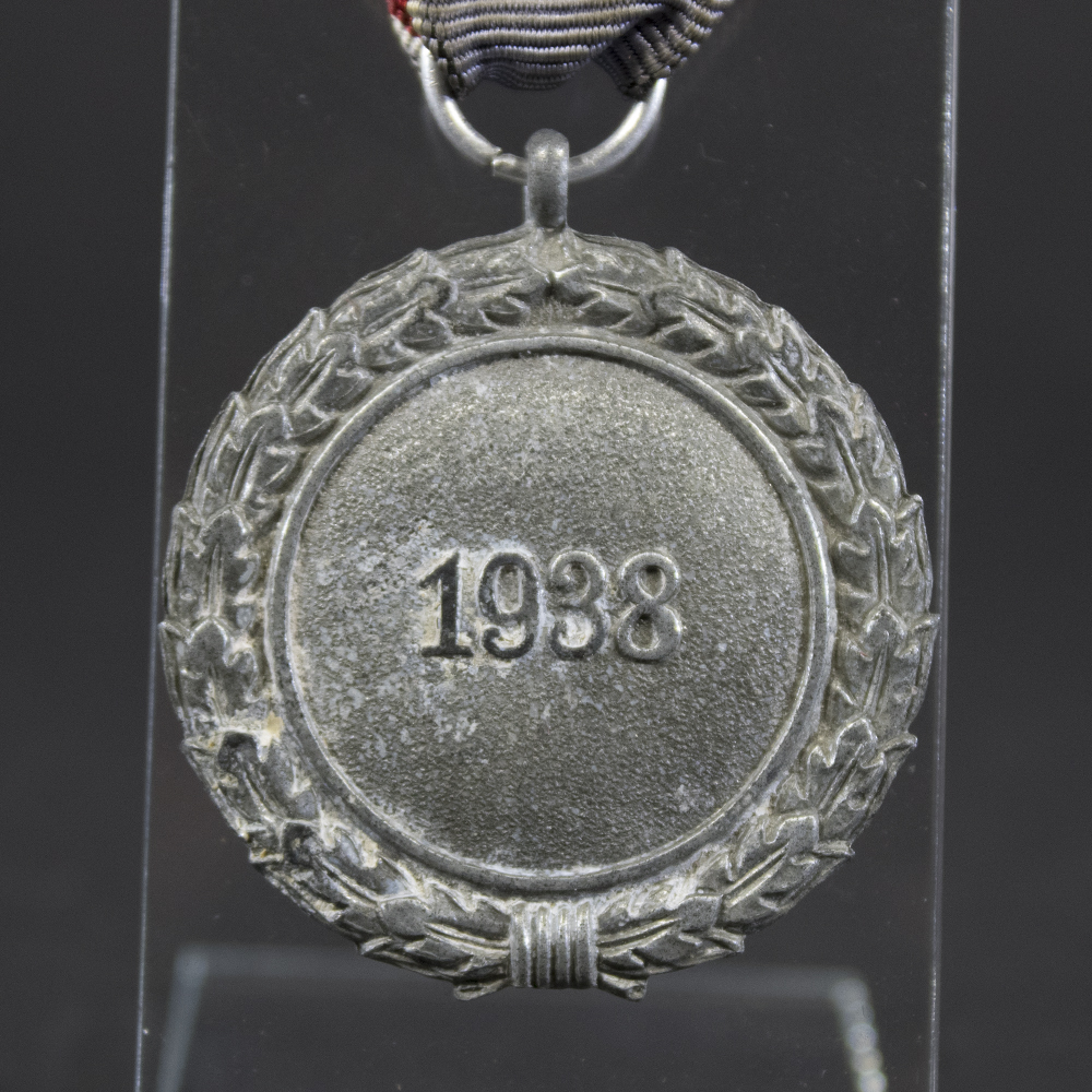 Detailed close-up of the Luftschutz medal’s front highlighting the swastika, and the 1938 inscription.