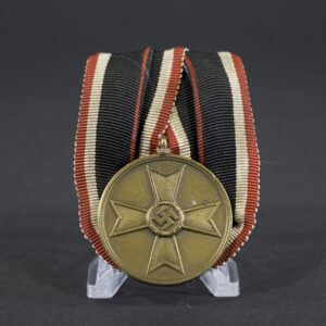Front of a German War Merit Medal showing a raised Maltese cross with a central swastika, surrounded by a smooth circular border.