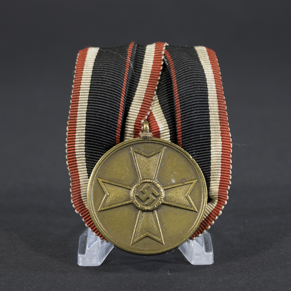 Front of a German War Merit Medal showing a raised Maltese cross with a central swastika, surrounded by a smooth circular border.