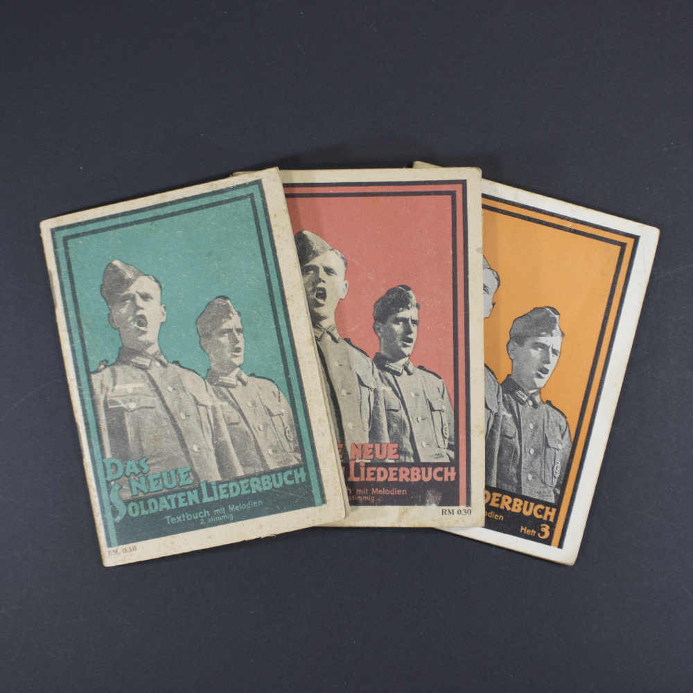 Front cover of the songbook ‘Das neue Soldaten Liederbuch’ showing the title in bold Gothic script, with a decorative border and military-themed illustration.