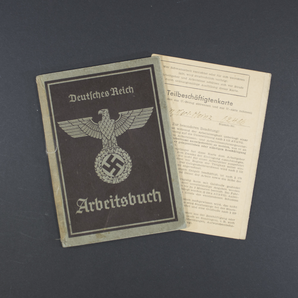 Front cover of a German World War II labor book (Arbeitsbuch), featuring the title ‘Arbeitsbuch’ in Gothic script, an eagle emblem with a swastika, and worn brown paper with visible creases.