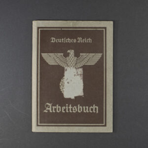 A worn, grayish-brown cover with the title “Arbeitsbuch” printed in bold black letters. Below the title is an eagle and swastika emblem, with official stamps and a serial number. The paper shows heavy creases and discoloration from age.