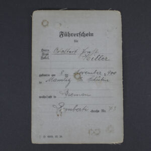 Front cover of a WWII German driver’s license showing the title in German, official emblem, and a textured paper surface with signs of age.