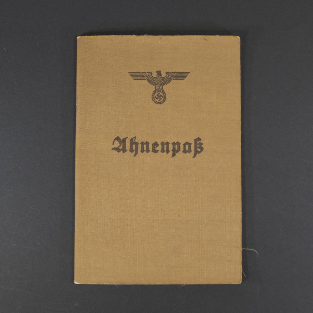Front cover of a German Ahnenpass, featuring Gothic script title ‘Ahnenpass’ and decorative border on aged beige paper.