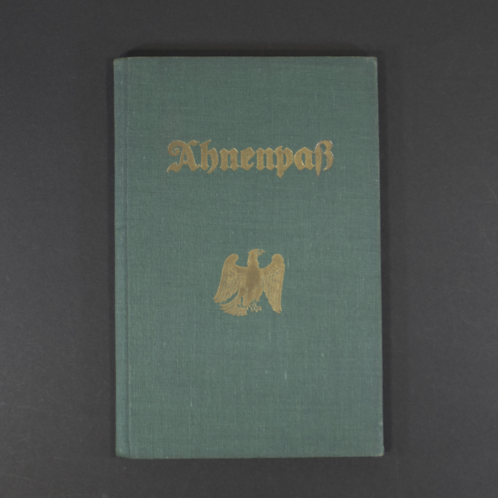 Front cover of a German Ahnenpass, featuring Gothic script title ‘Ahnenpass’ and decorative border on aged green paper.