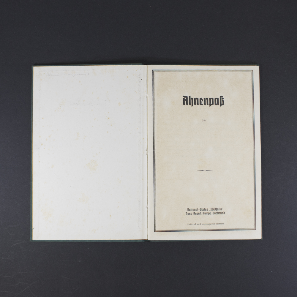 Inside pages of the Ahnenpass showing handwritten entries, official stamps, and printed sections for family lineage and ancestry details in German text