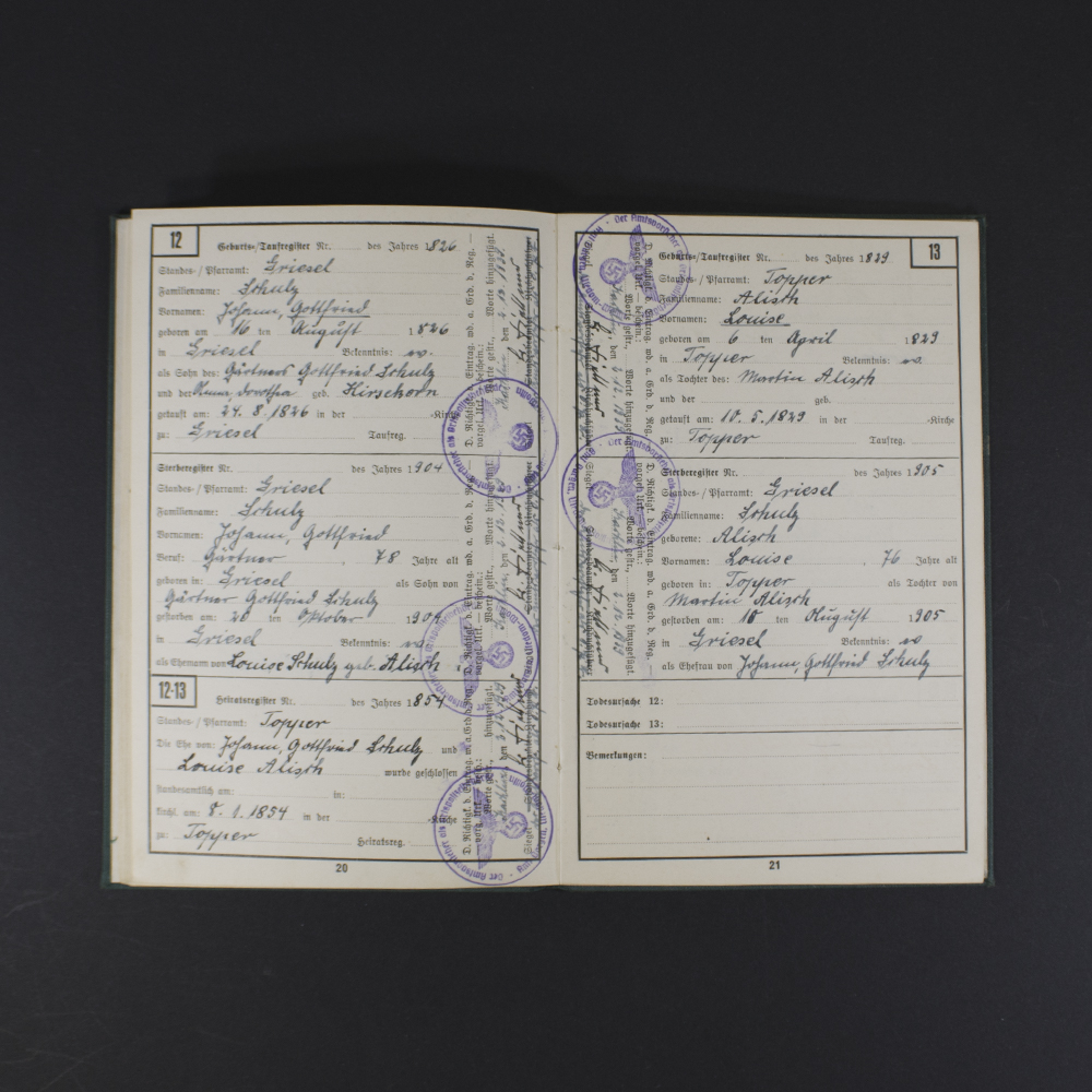 Inside pages of the Ahnenpass showing handwritten entries, official stamps, and printed sections for family lineage and ancestry details in German text