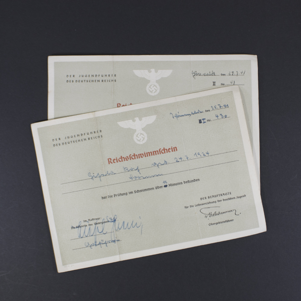 Overview of the 2 Reichsschwimmschein showing an German Eagle with swastika and German writing