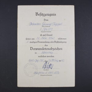 Front side of the award document for a World War II Black Wound Badge, showing printed text, official stamp, and handwritten details.