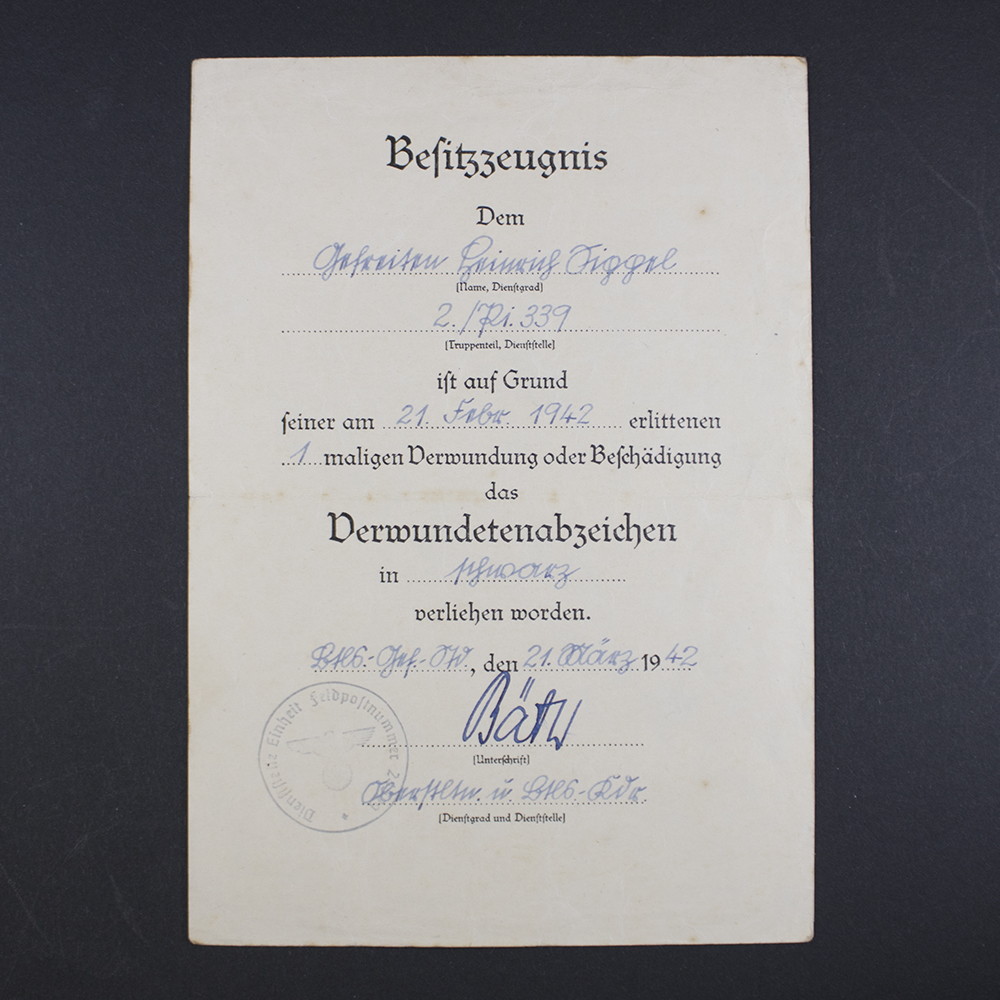 Front side of the award document for a World War II Black Wound Badge, showing printed text, official stamp, and handwritten details.