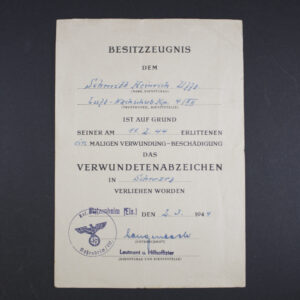 Front side of the award document for a World War II Black Wound Badge, showing printed text, official stamp, and handwritten details.