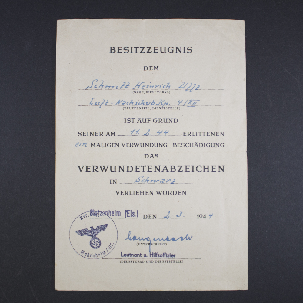 Front side of the award document for a World War II Black Wound Badge, showing printed text, official stamp, and handwritten details.