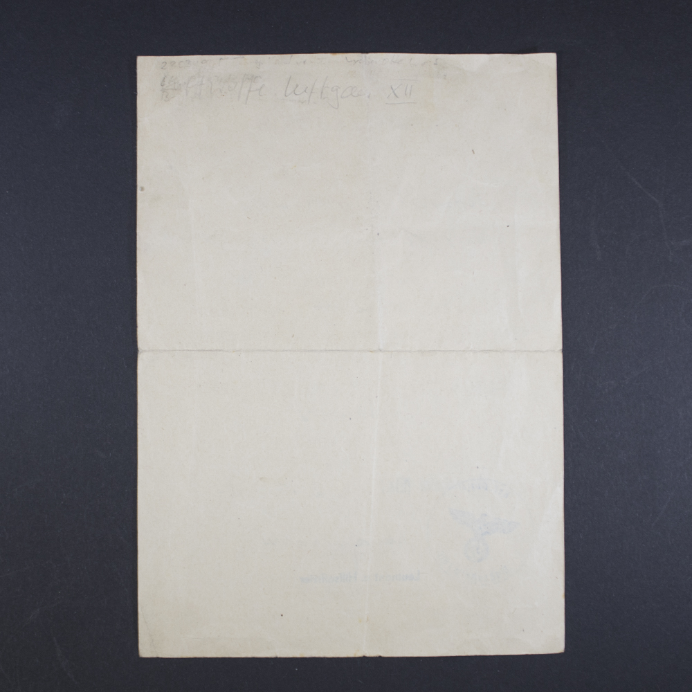 Clear back side of the award document, displaying paper texture and any visible marks or aging.