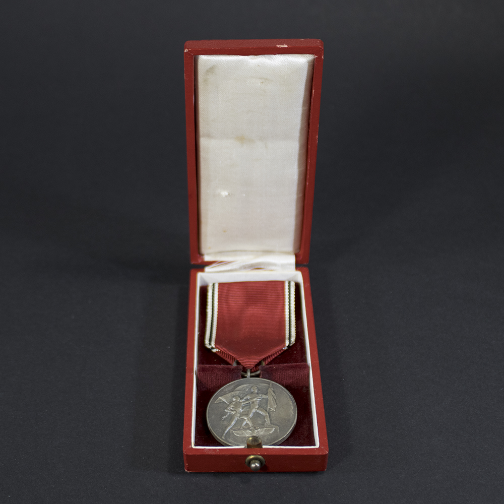Full view of the WW2 Austria Occupation Medal displayed inside its original case, showing medal and ribbon.