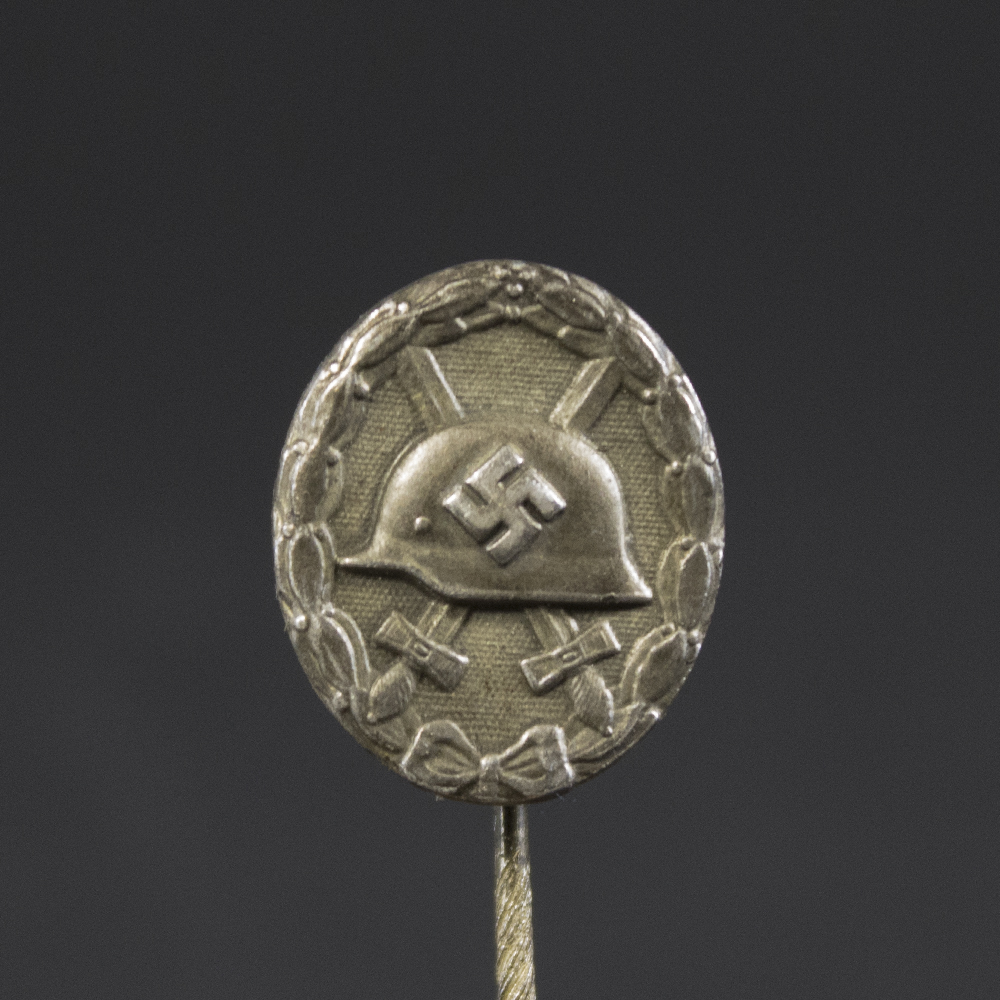 Detailed close-up of the front side of the WW2 silver wound badge, highlighting the embossed design and silver finish.