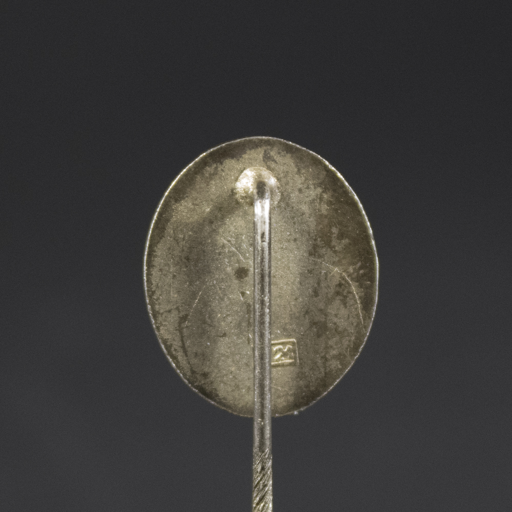 Close-up of the reverse side of the WW2 silver wound badge pin, showing the pin clasp and the maker’s mark ‘L/21’ stamped on the back