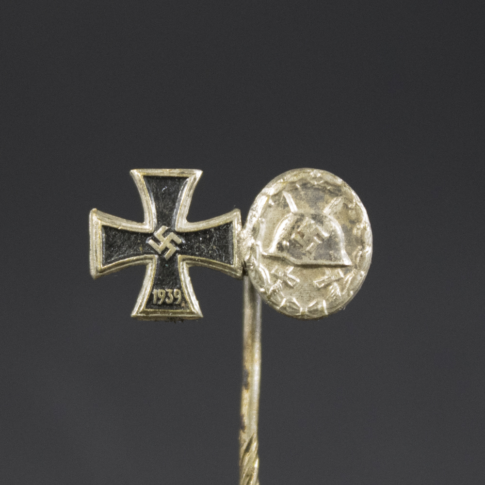 Detailed view of the front showing the Iron Cross with its black core and silver edges, alongside the oval wound badge with a helmet and crossed swords design.