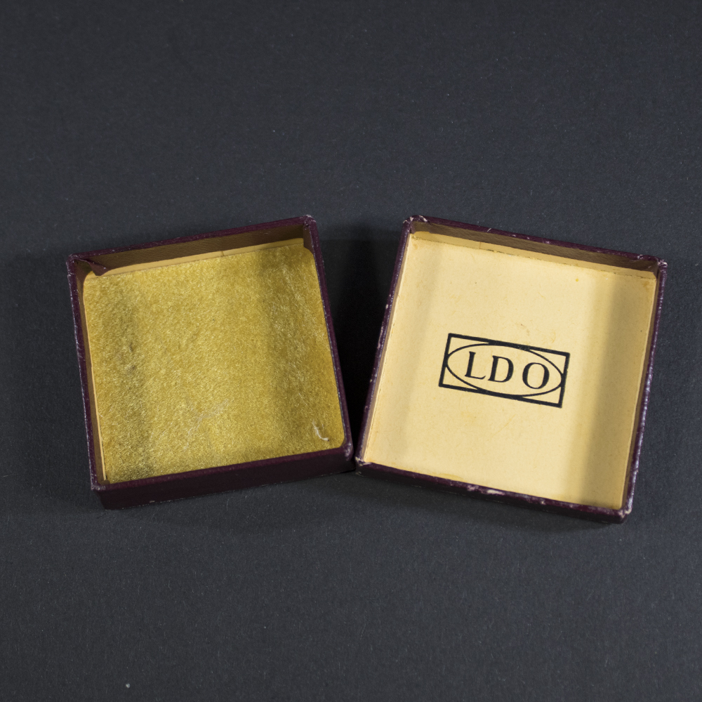 Full view of the LDO case for a Mother’s Cross miniature, showing its square shape and overall condition