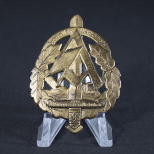 A German WWII SA Sports and Military Competition participant badge from Niederrhein, 1937. Oval-shaped with a bronze finish, featuring a central sword overlaid on a swastika, surrounded by an oak leaf wreath. Text around the edge reads “SA Sport- u. Wehr-Wettkämpfe Niederrhein 1937.”