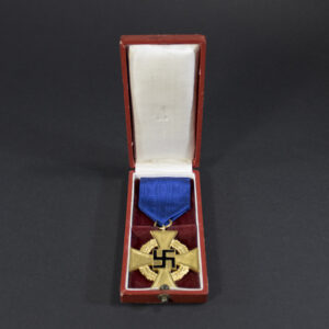 The Faithful Service Medal displayed inside its original dark-colored case. The medal is silver-toned with a blue ribbon, resting on a velvet lining.