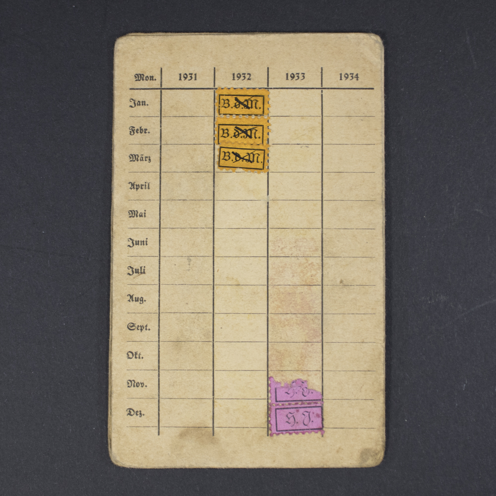 Back cover of the BDM membership pass, with minimal design and a small logo near the bottom.