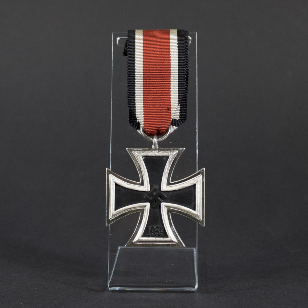 Full view of a World War II Iron Cross 2nd Class medal with ribbon, showing overall design and condition.