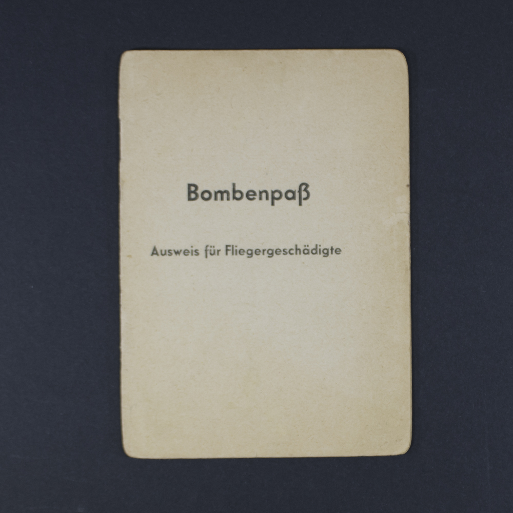 Front cover of the item, showing title in German script with emblem and aged texture