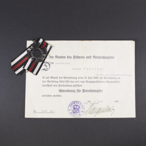 “Overview of the Frontkämpfer set, showing the medal placed alongside its award document. The medal is oval-shaped with embossed design, and the document features Gothic-style German text and official stamps.”