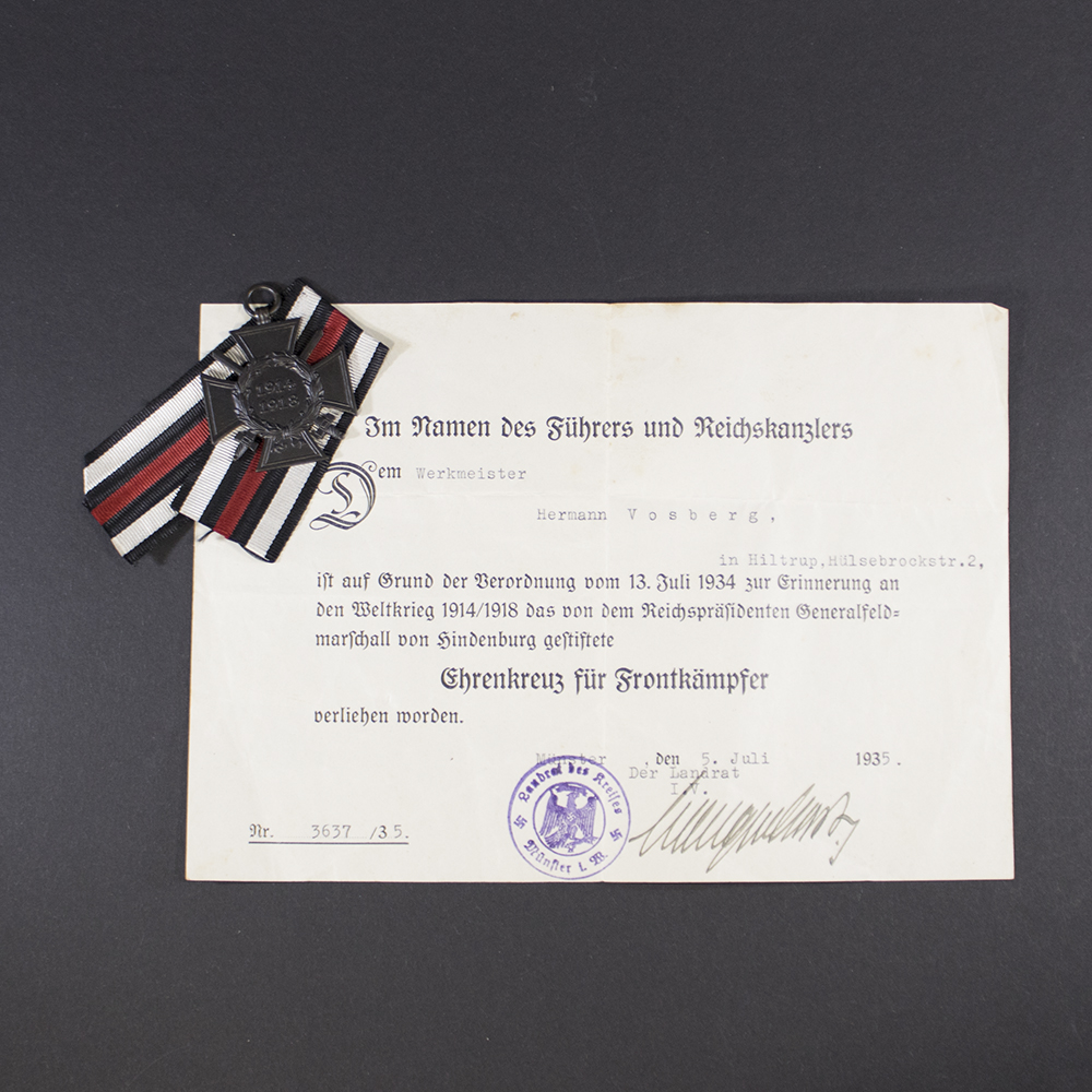 “Overview of the Frontkämpfer set, showing the medal placed alongside its award document. The medal is oval-shaped with embossed design, and the document features Gothic-style German text and official stamps.”