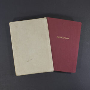 Full view of the German ‘Mein Kampf’ red Tornister edition placed alongside its matching red slipcase, showing the book partially inserted.