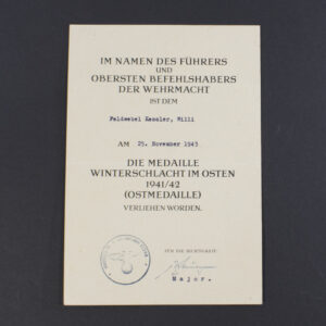 Front side of a World War II German Eastern Front award document, featuring official printed text in German, decorative border, and handwritten recipient details.