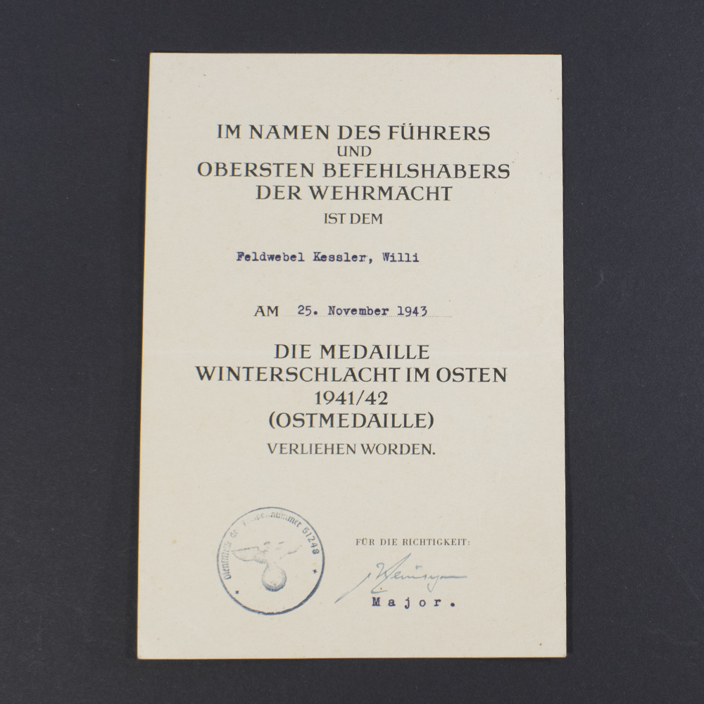 Front side of a World War II German Eastern Front award document, featuring official printed text in German, decorative border, and handwritten recipient details.