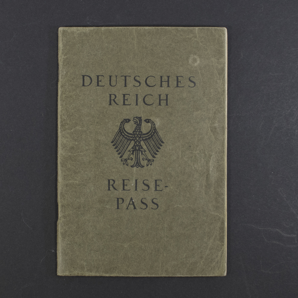 Front cover of a German WWII-era Reisepass, dark textured cover with the imperial eagle emblem and German text.