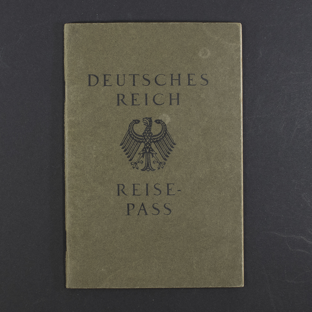 Front cover of a German WWII-era Reisepass, dark textured cover with the imperial eagle emblem and German text.