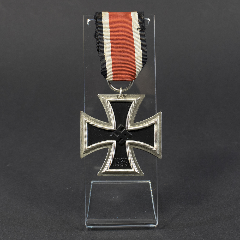 World War II German Iron Cross 2nd Class medal displayed flat, showing its blackened iron core with silver frame and suspension ring