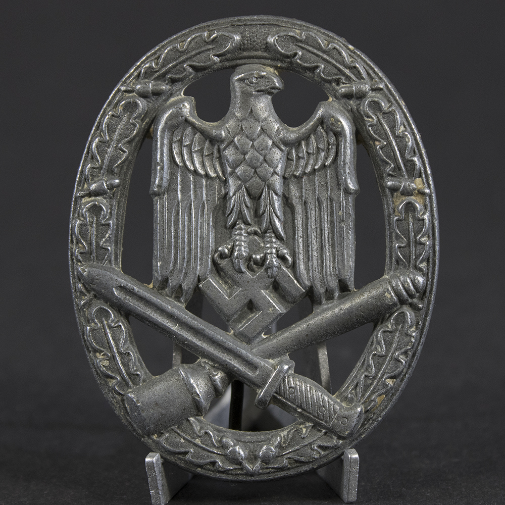 Close-up of the front of a WWII German General Assault Badge, showing detailed relief of the eagle, wreath, and crossed weapons.