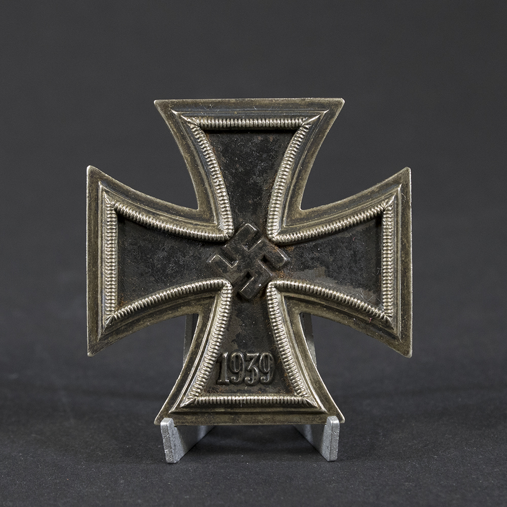 World War II German Iron Cross 1st Class displayed on a flat surface, showing its silver frame and black core