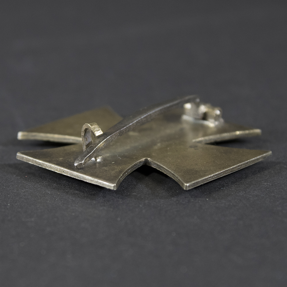 Detailed view of the catch on the back of the Iron Cross 1st Class, highlighting the clasp design and metal texture.