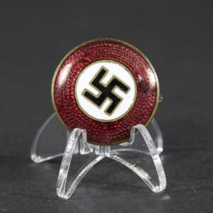 NSDAP sympathizer badge from World War II displayed on a flat surface.