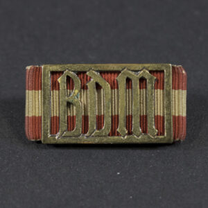 World War II German BDM Performance Badge displayed on a flat surface, showing its oval shape and detailed design.